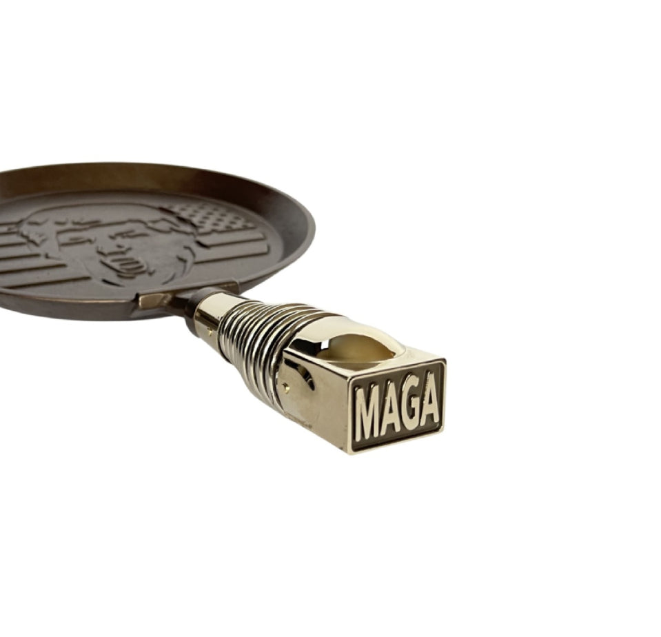 MAGA PANCAKES' commemorative President Trump skillet, MAGAPAN, hand-finished with spring handle hardware cast in high-quality Bronze, and given a patina before assembly that ages beautifully over time. Finish may naturally vary. 